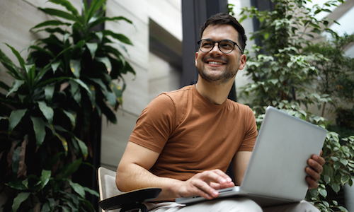 smiling man working on a computer