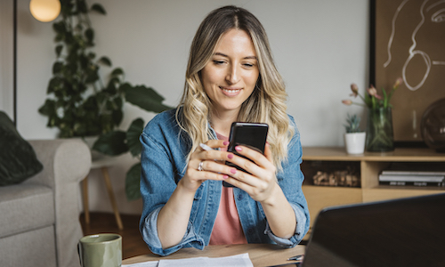 smiling woman working on her phone