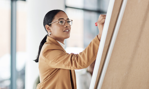 business woman writing on a board