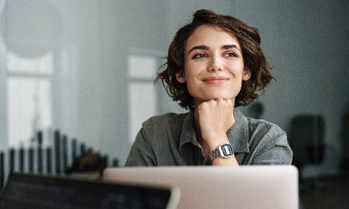 smiling woman in front of computer