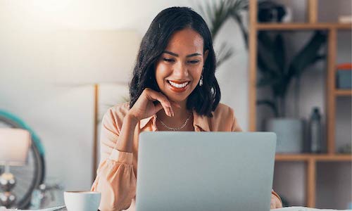 smiling woman looks at a computer