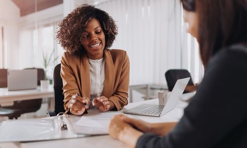 woman in blazer smiling during an interview