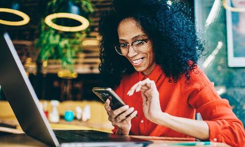 smiling woman working on her phone